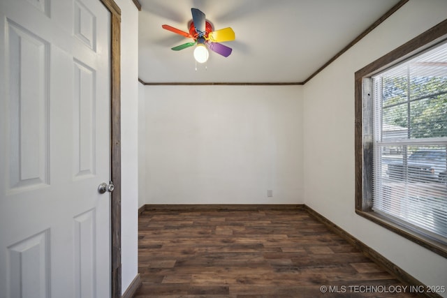 unfurnished room with baseboards, dark wood-style floors, ceiling fan, and crown molding