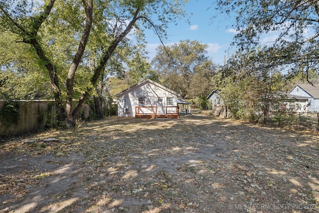 view of yard with a wooden deck and fence