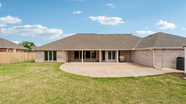 rear view of house featuring brick siding, cooling unit, a shingled roof, and fence