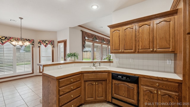 kitchen featuring light countertops, dishwasher, visible vents, a sink, and a peninsula
