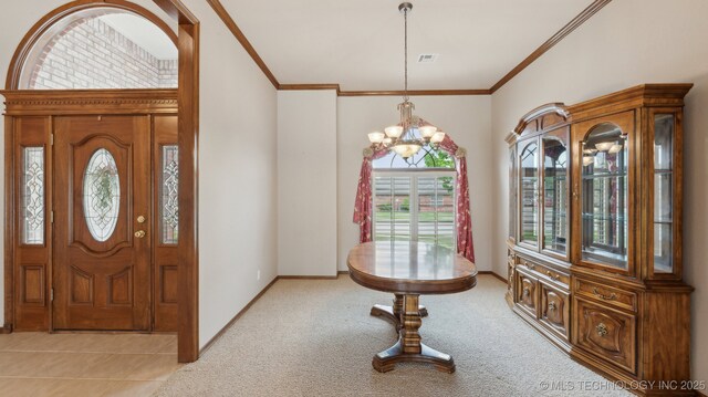 entryway featuring baseboards, light carpet, crown molding, and an inviting chandelier