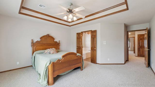 bedroom featuring light carpet, baseboards, visible vents, and a raised ceiling