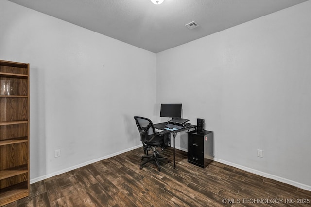 office area with wood finished floors, visible vents, and baseboards