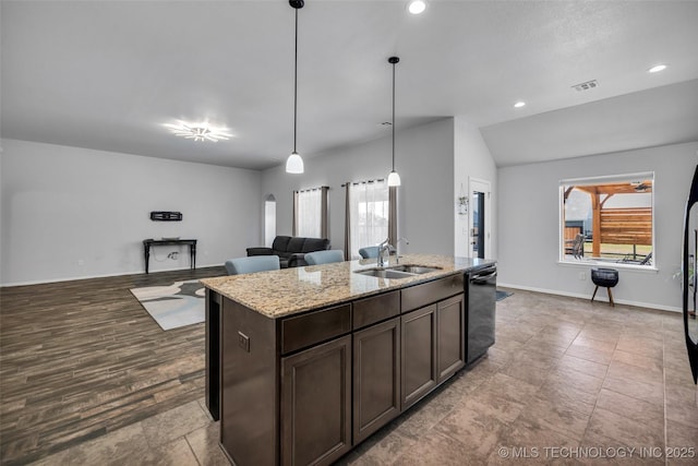 kitchen featuring a sink, open floor plan, dark brown cabinetry, black dishwasher, and light stone countertops