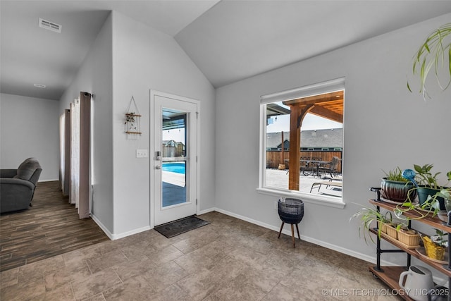 doorway to outside with lofted ceiling, baseboards, and visible vents