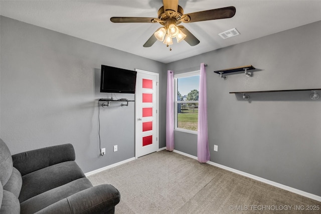 sitting room featuring baseboards, visible vents, ceiling fan, and carpet flooring