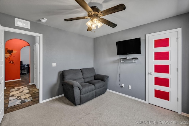 sitting room featuring baseboards, a ceiling fan, visible vents, and carpet