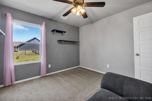 sitting room featuring carpet flooring, a ceiling fan, and baseboards