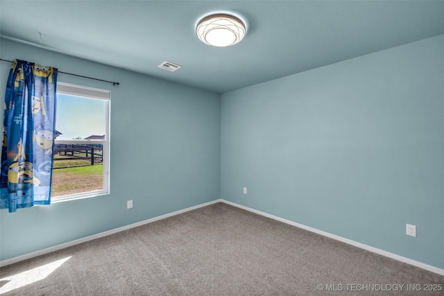 carpeted empty room with baseboards and visible vents