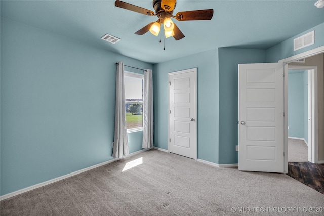 unfurnished bedroom featuring baseboards, visible vents, carpet flooring, and ceiling fan