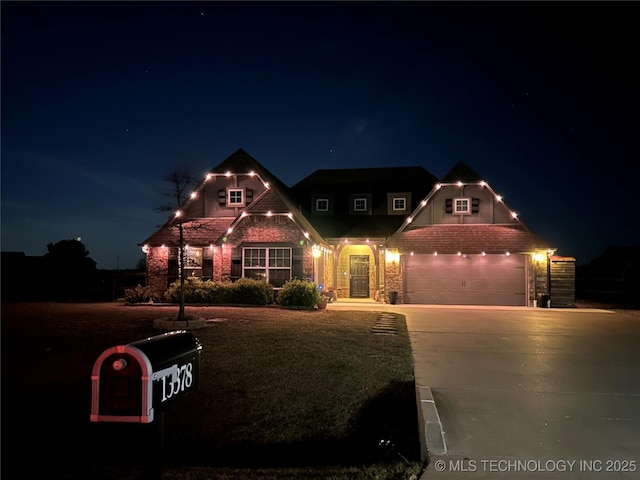 craftsman-style house with brick siding and driveway