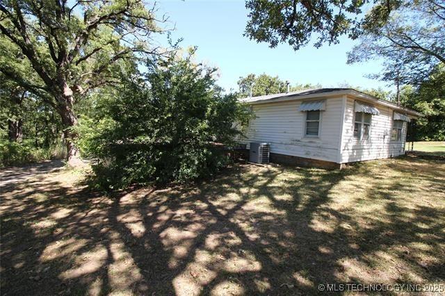 988 Wilson St, Durant, OK 74701 - view of home's exterior with central AC unit