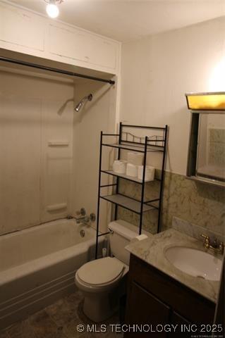 988 Wilson St, Durant, OK 74701 - bathroom featuring washtub / shower combination, tasteful backsplash, toilet, and vanity