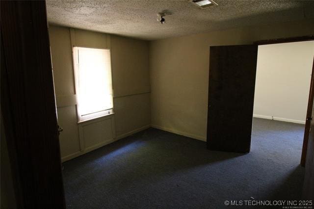 988 Wilson St, Durant, OK 74701 - carpeted spare room with a textured ceiling and visible vents