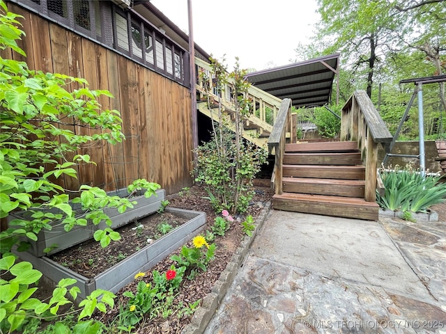 view of yard featuring a garden and stairs