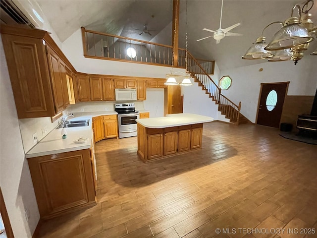 kitchen featuring high vaulted ceiling, a sink, ceiling fan, white microwave, and electric range