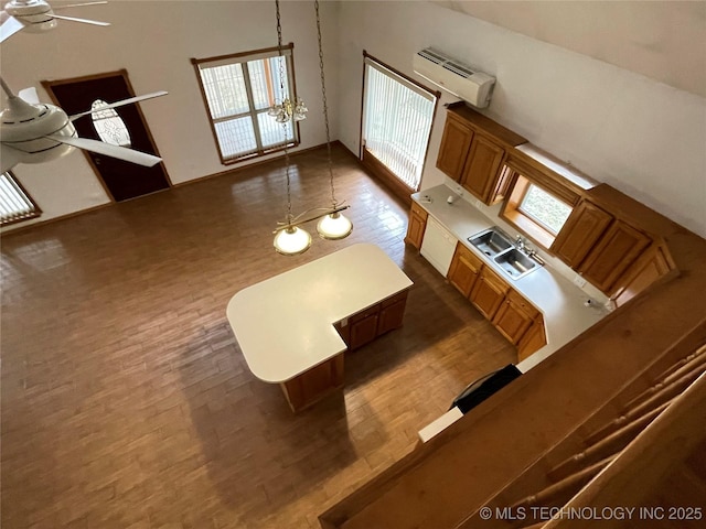 living room featuring dark wood finished floors, an AC wall unit, and a ceiling fan