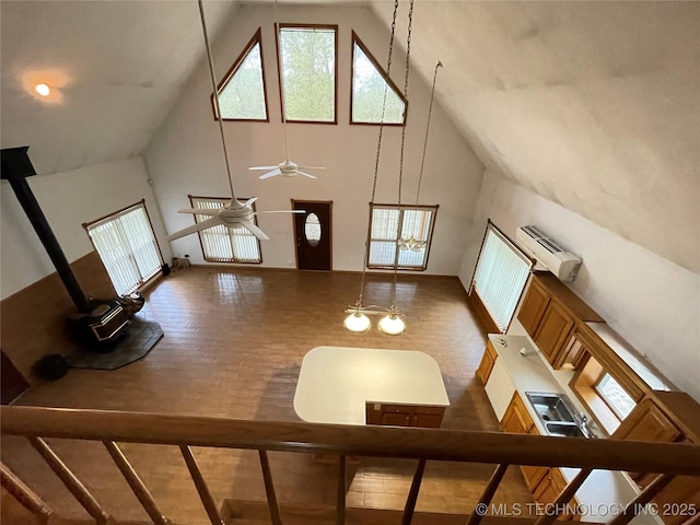 116500 S 4249th Rd, Eufaula, OK 74432 - living room featuring high vaulted ceiling, a wood stove, plenty of natural light, ceiling fan, and baseboards