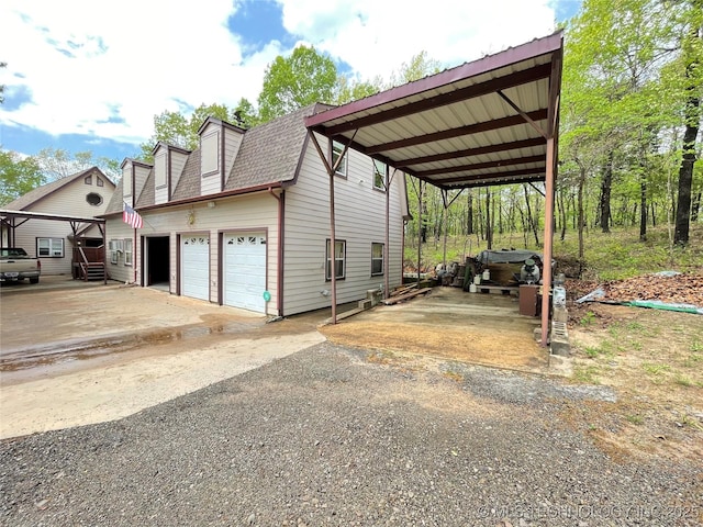 view of home's exterior with roof with shingles and aphalt driveway