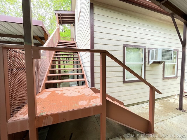 wooden deck featuring stairs and a wall mounted AC