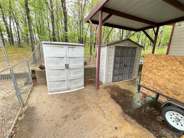 view of shed featuring fence