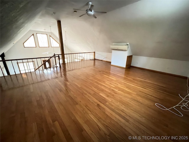 bonus room featuring baseboards, vaulted ceiling, wood finished floors, and ceiling fan