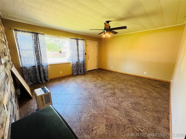 503 NW 2nd St, Checotah, OK 74426 - spare room with a ceiling fan and baseboards