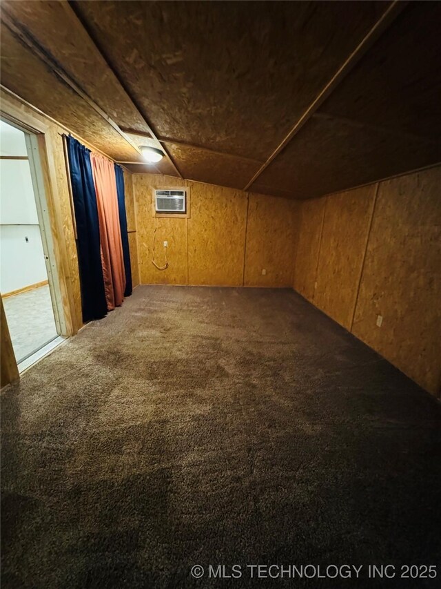 503 NW 2nd St, Checotah, OK 74426 - finished below grade area featuring wooden walls, carpet, and a wall unit AC