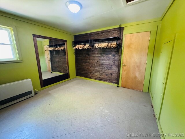 503 NW 2nd St, Checotah, OK 74426 - spare room with radiator heating unit, tile patterned floors, and heating unit
