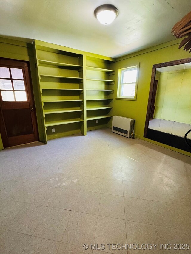503 NW 2nd St, Checotah, OK 74426 - empty room with tile patterned floors and heating unit