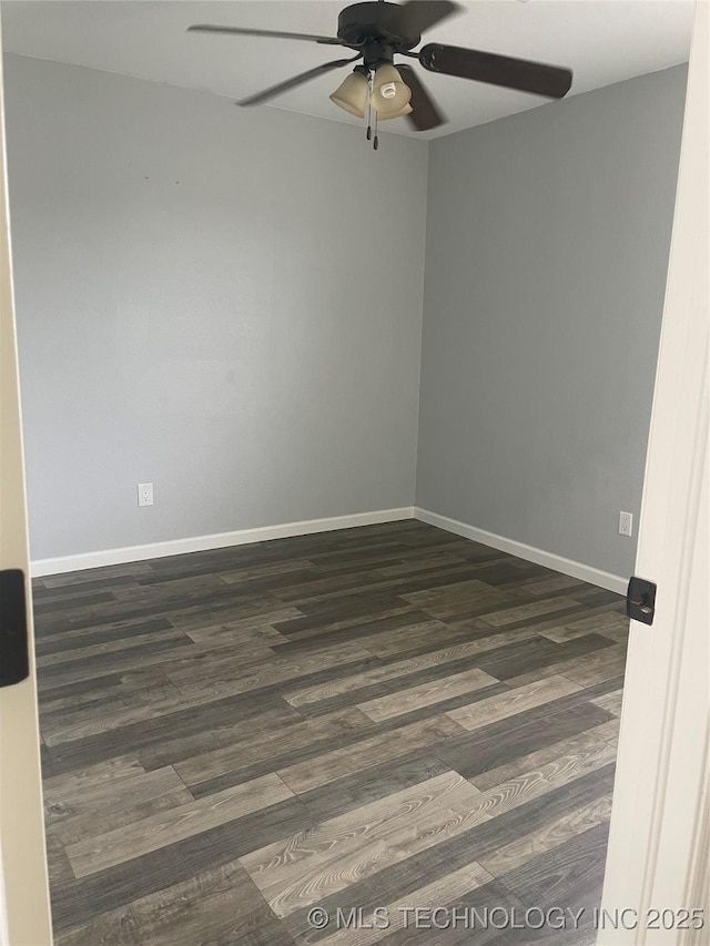 unfurnished room featuring dark wood finished floors, baseboards, and ceiling fan