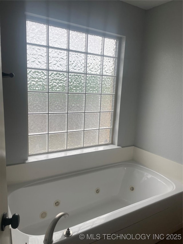 bathroom with a jetted tub