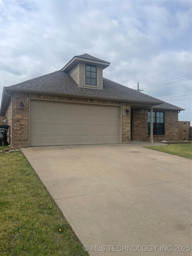 view of front of property featuring an attached garage, driveway, and brick siding