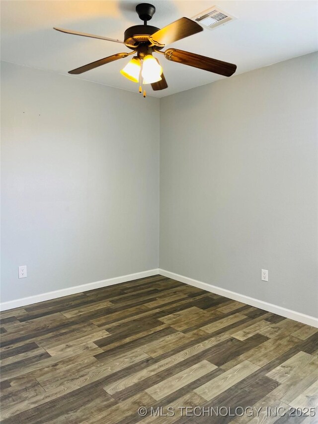 9700 E 110th St N, Owasso, OK 74055 - spare room featuring wood finished floors and a ceiling fan