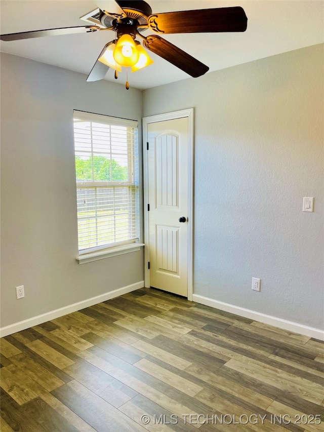 9700 E 110th St N, Owasso, OK 74055 - unfurnished room featuring a ceiling fan and wood finished floors