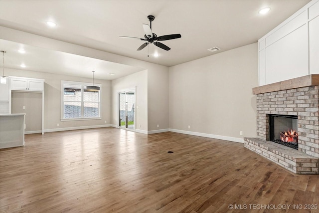 4231 W 4th St, Skiatook, OK 74070 - unfurnished living room featuring wood finished floors, a fireplace, a ceiling fan, and recessed lighting