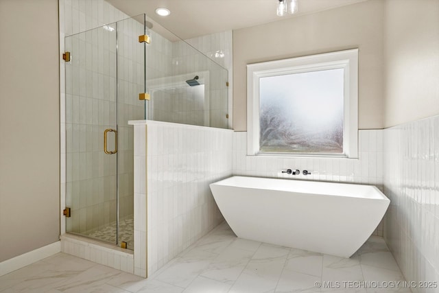 4231 W 4th St, Skiatook, OK 74070 - full bath featuring marble look tiles, a freestanding tub, tile walls, and a stall shower