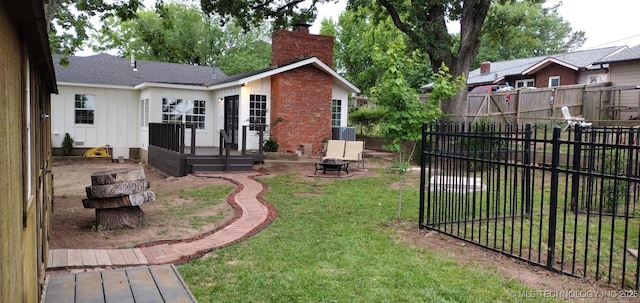 view of yard with a fire pit and a wooden deck