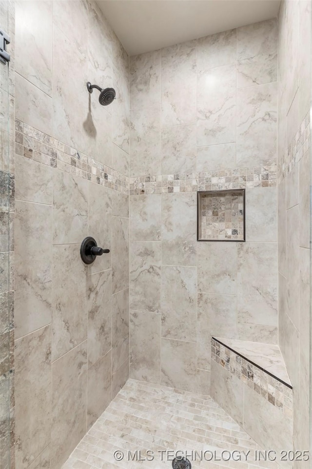 full bath featuring tiled shower