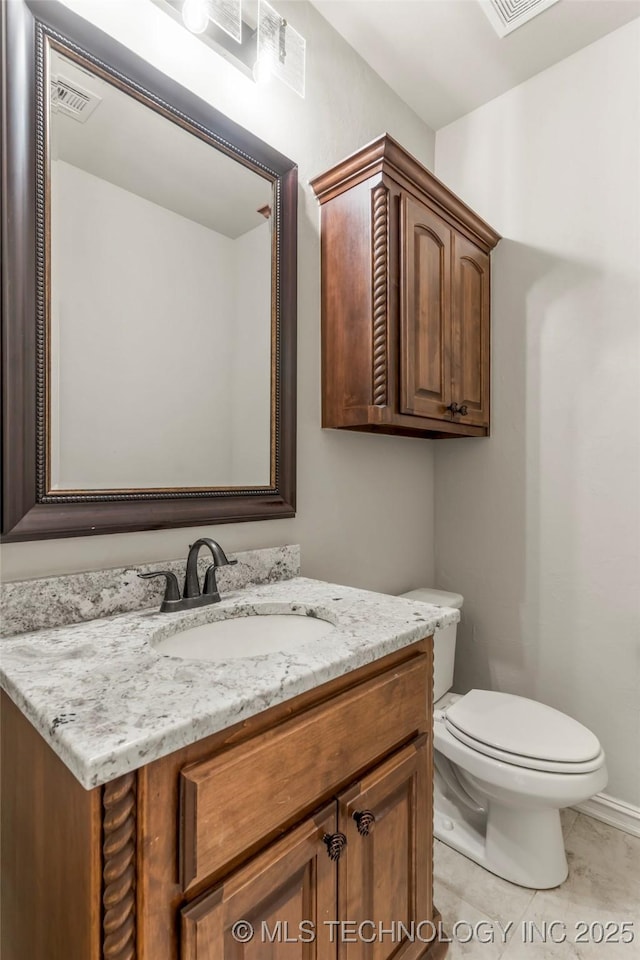 half bath with tile patterned flooring, visible vents, toilet, and vanity
