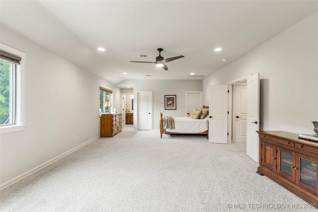 bedroom featuring visible vents, light colored carpet, and multiple windows