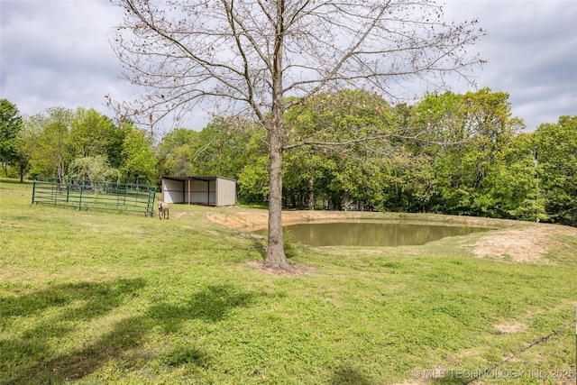 3633 Sawmill, Caddo, OK 74729 - view of yard with a pole building, a water view, a carport, fence, and an outbuilding