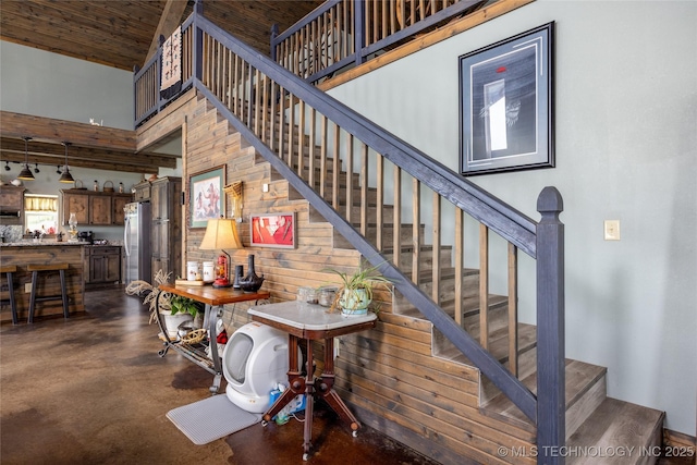 3633 Sawmill, Caddo, OK 74729 - stairway featuring finished concrete flooring and a towering ceiling