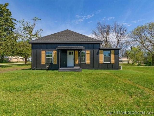 322 W Seneca St, Nowata, OK 74048 - exterior space with board and batten siding, a shingled roof, and a front yard