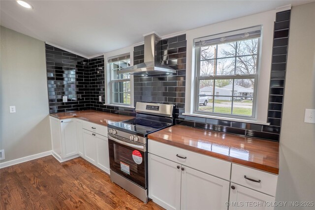 322 W Seneca St, Nowata, OK 74048 - kitchen featuring stainless steel electric range oven, a wealth of natural light, wooden counters, and wall chimney range hood