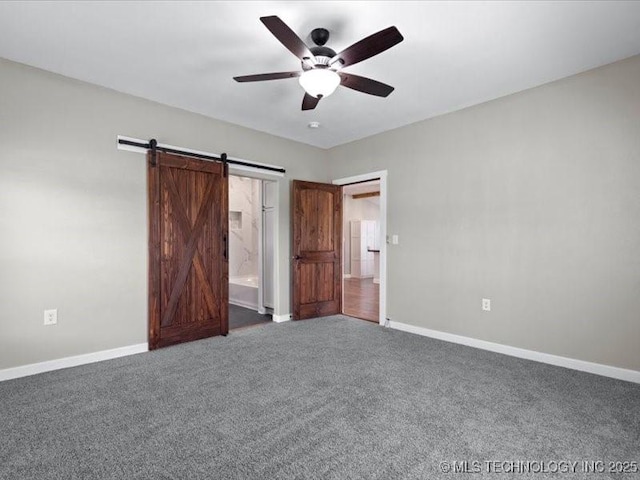 322 W Seneca St, Nowata, OK 74048 - unfurnished bedroom featuring a barn door, baseboards, a ceiling fan, and carpet floors