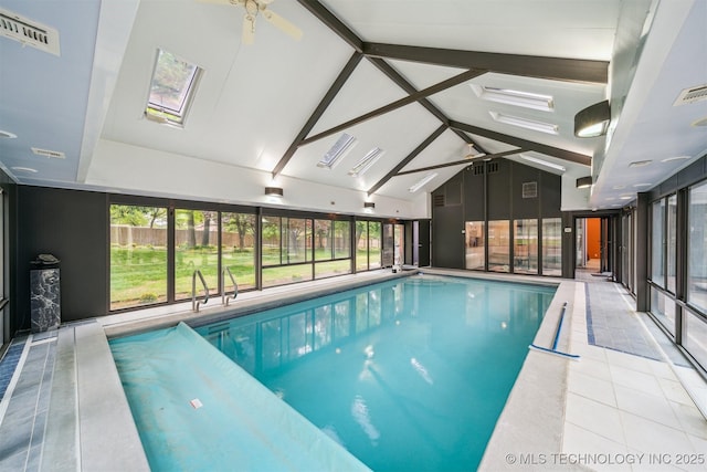 pool with a skylight and ceiling fan