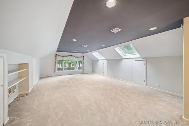 bonus room with baseboards, visible vents, lofted ceiling with skylight, and light colored carpet