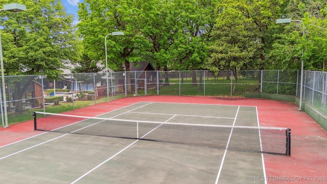 view of sport court featuring fence