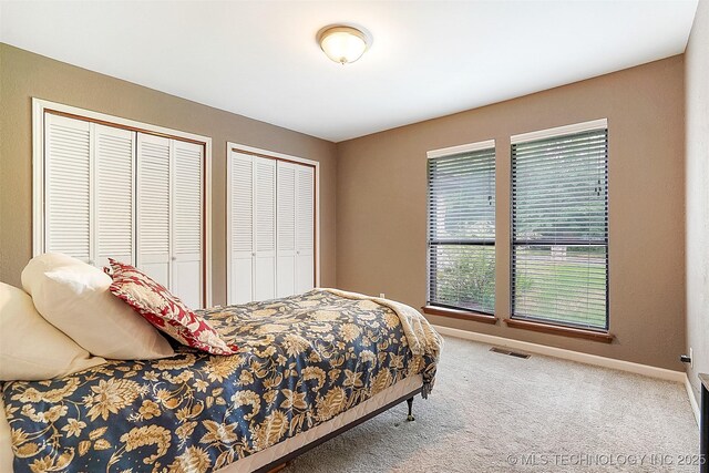 501 E Yuma Dr, Broken Arrow, OK 74011 - bedroom with visible vents, multiple closets, carpet flooring, and baseboards